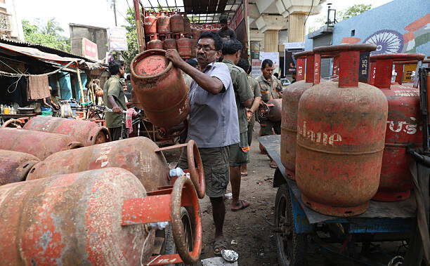 Men handling gas cylinders in market